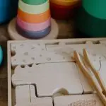 Close-up of vibrant wooden toys and puzzle pieces for kids. Ideal for playrooms.